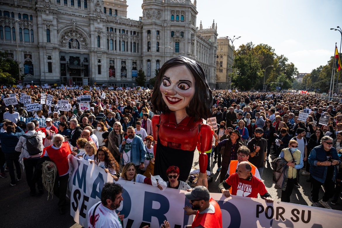 Protesters carrying a large figure of Isabel Diaz Ayus