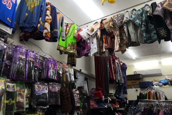 A photo of a shop selling hair extensions and various clothing.
