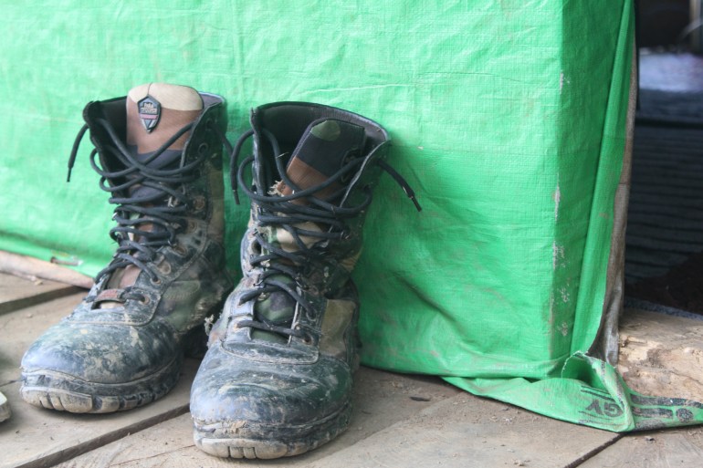 A pair of muddy combat boots from a Chin fighter left outside a hut