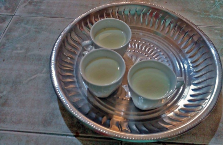 Cups of milk on a tray