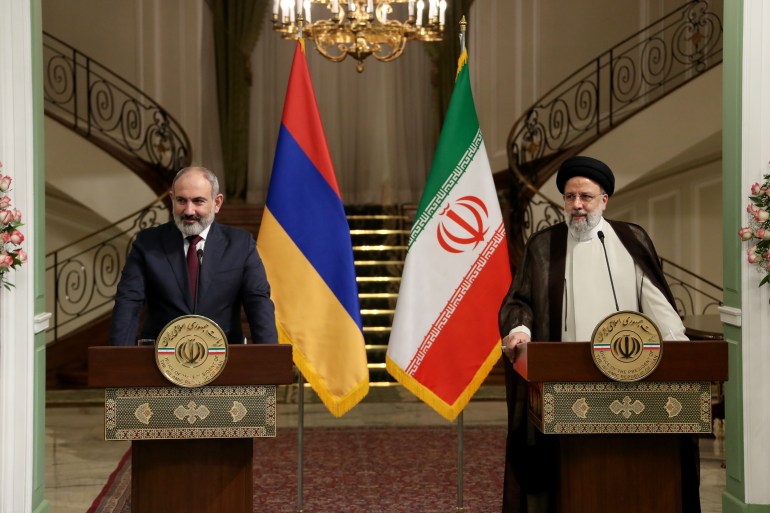 Armenian Prime Minister Nikol Pashinyan, left, and Iranian President Ebrahim Raisi hold a press conference in Tehran, Iran
