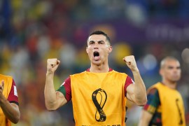 Ronaldo triumphant, holding up his fisted hands against a blurred background