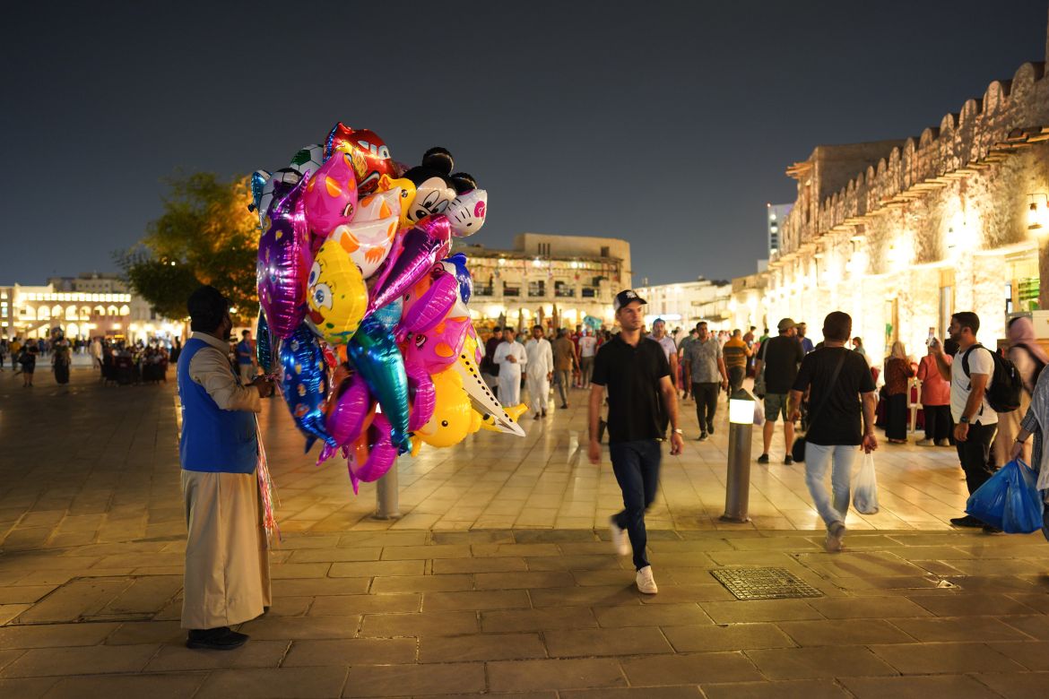 A man holding balloons at Souq Waqif, Doha