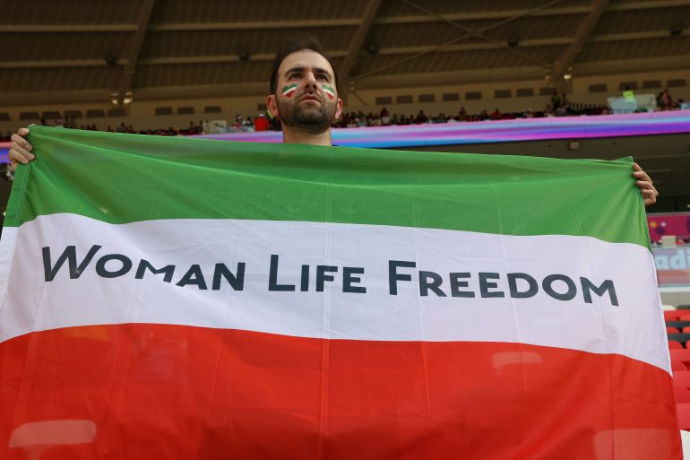 woman life freedom written on a flag