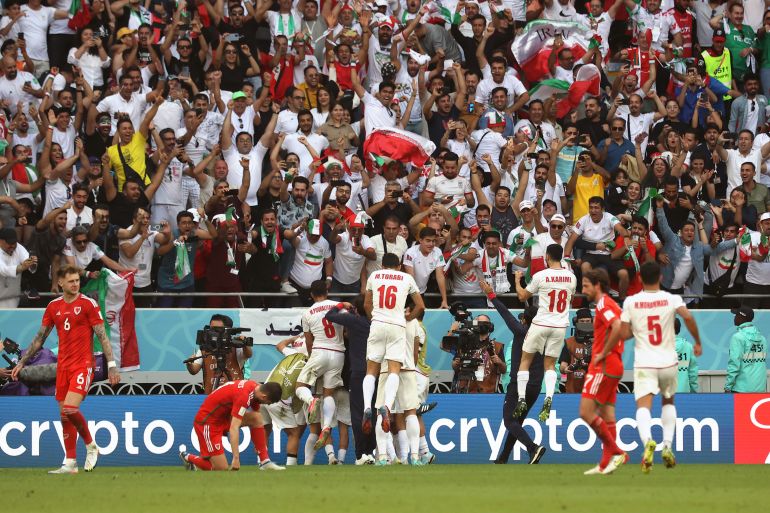 Iranian players celebrating in front of the crowd