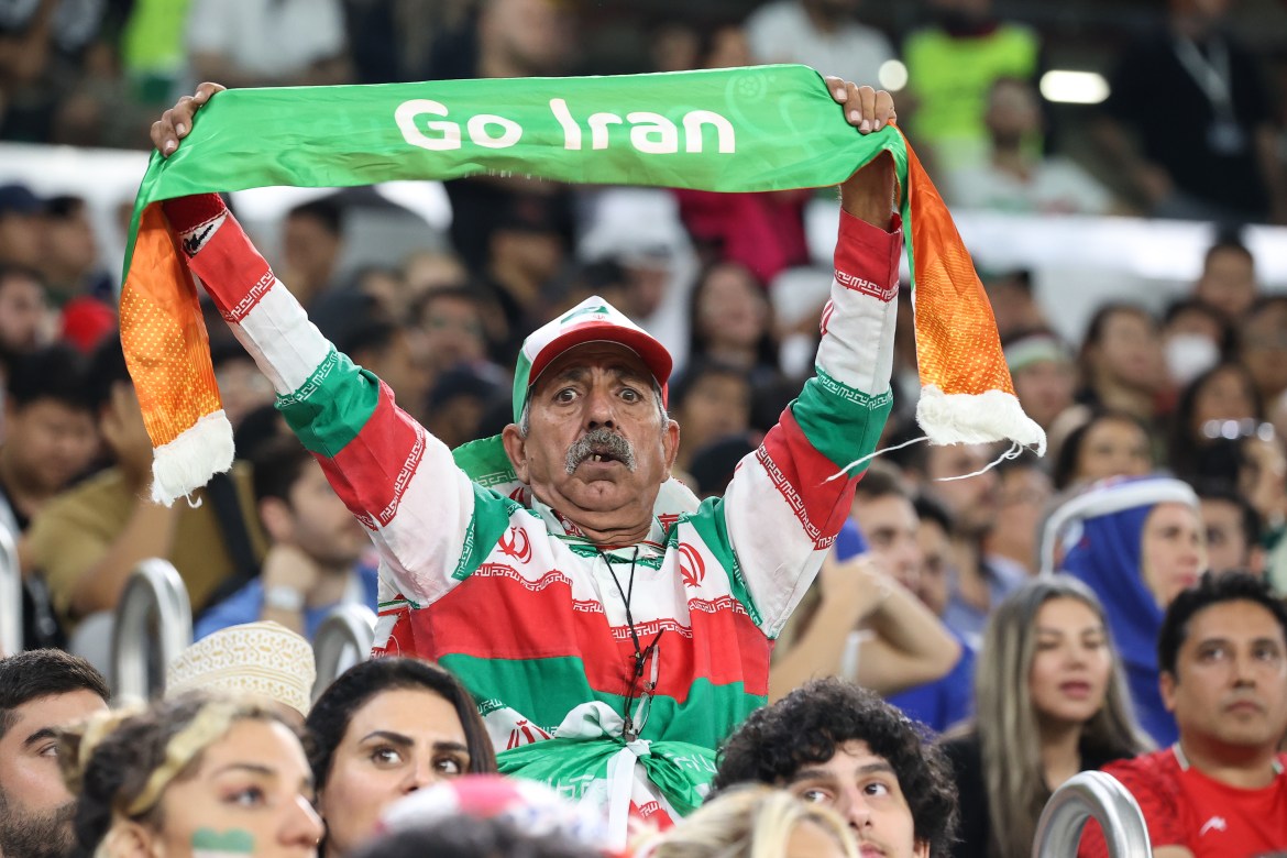 Iran fan in the stands cheering for his side