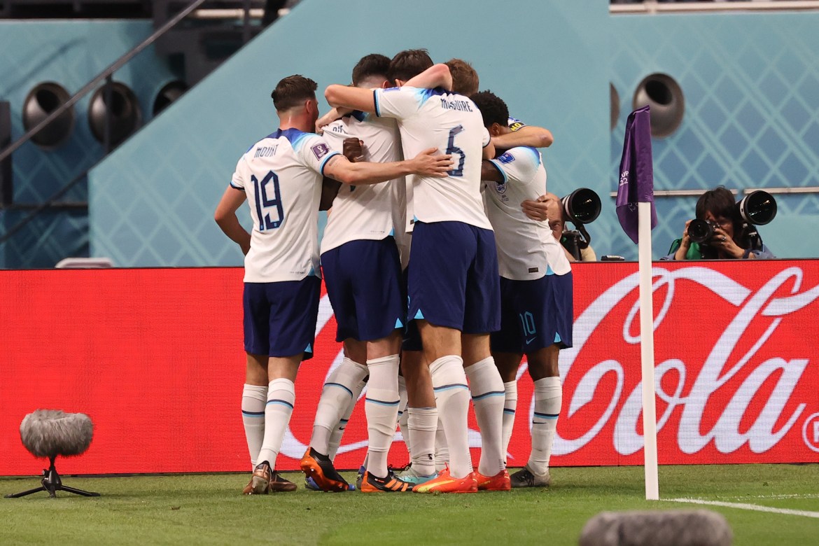 England players huddle in celebration in Doha, Qatar