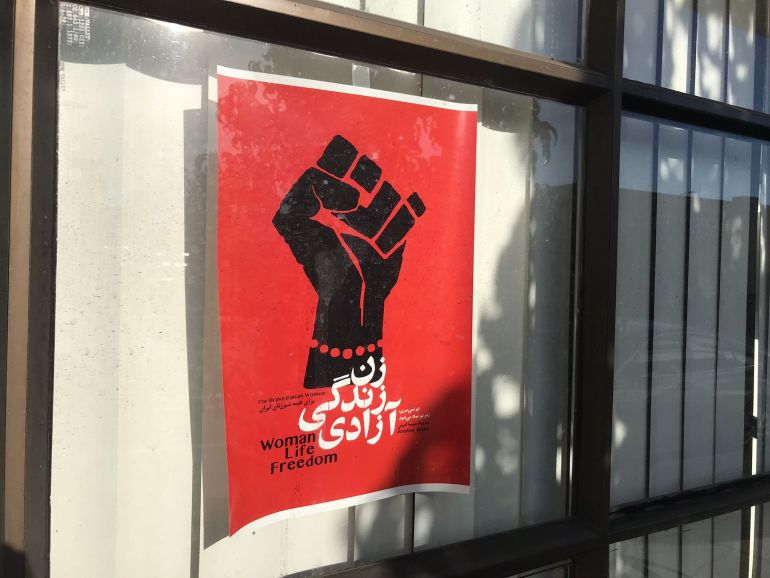 A poster of a raised fist with a red background