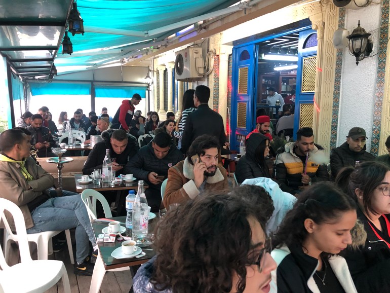 An Arabic tea house in Tunis filled with customers watching the Tunisia vs Denmark World Cup match [Elizia Volkmann/Al Jazeera]