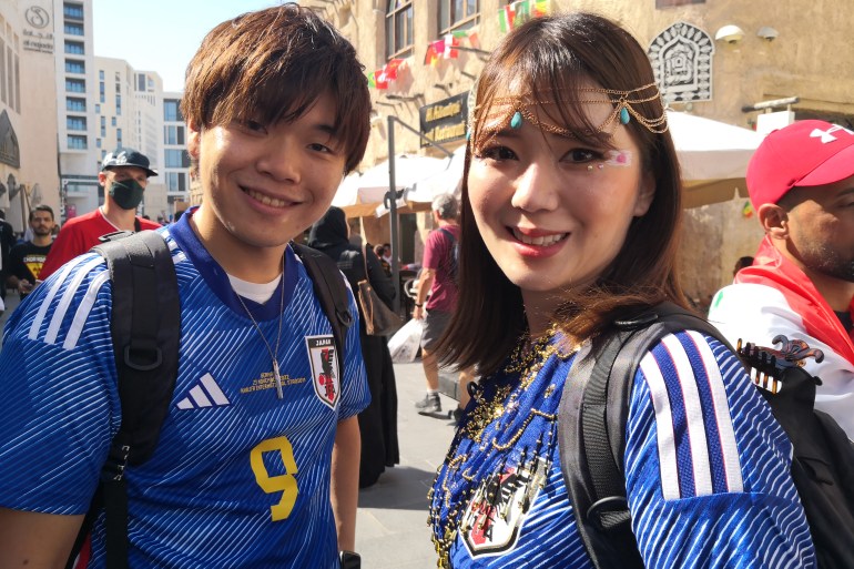 Saysuka in blue Japanese uniform and friend smile at the camera