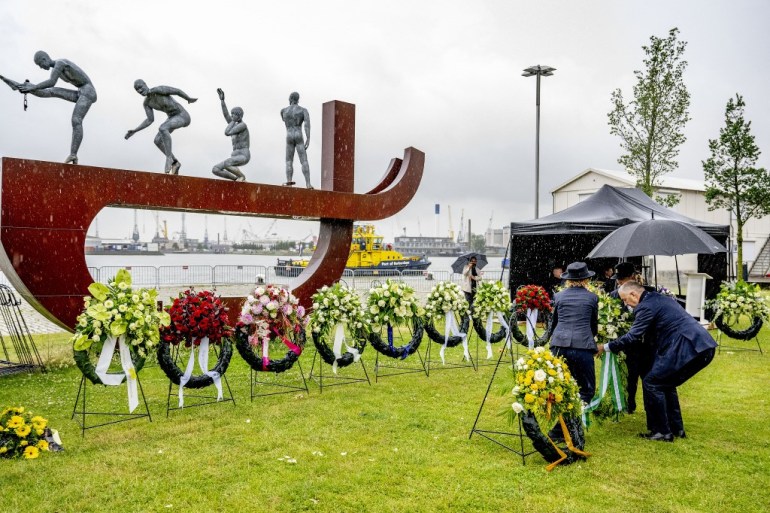 Rotterdam's Dutch Mayor Ahmed Aboutaleb (R) lays a wreath of flowers during the commemoration of the abolition of slavery in Suriname and the Caribbean Netherlands, in Rotterdam