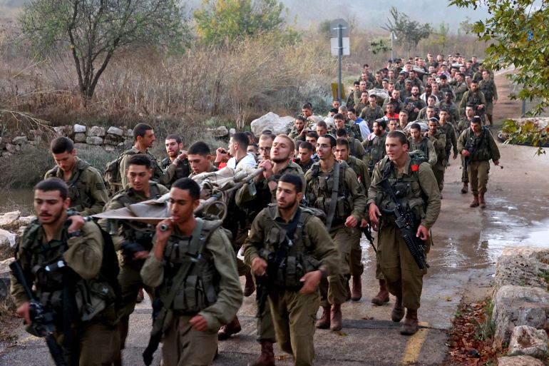 Newly-recruited Israeli paratroopers march in full combat gear on a 50-kilometre 12-hour hike in the mountains near Jerusalem on November 10, 2022.