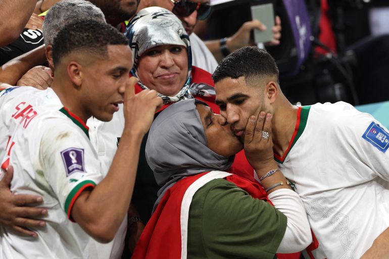 Morocco's defender Achraf Hakimi (R) is greeted by his mother beside midfielder Abdelhamid Sabiri (L) at the end of the Qatar 2022 World Cup Group F football match between Belgium and Morocco at the Al Thumama Stadium in Doha on November 27, 2022