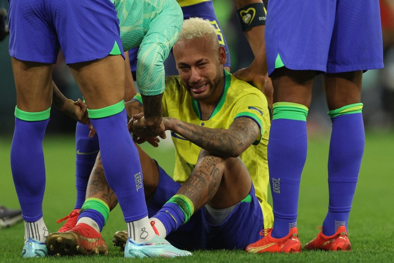 Brazil's forward Neymar sitting on the pitch in tears after his team lost the Qatar 2022 World Cup quarterfinal football match between Croatia and Brazil.