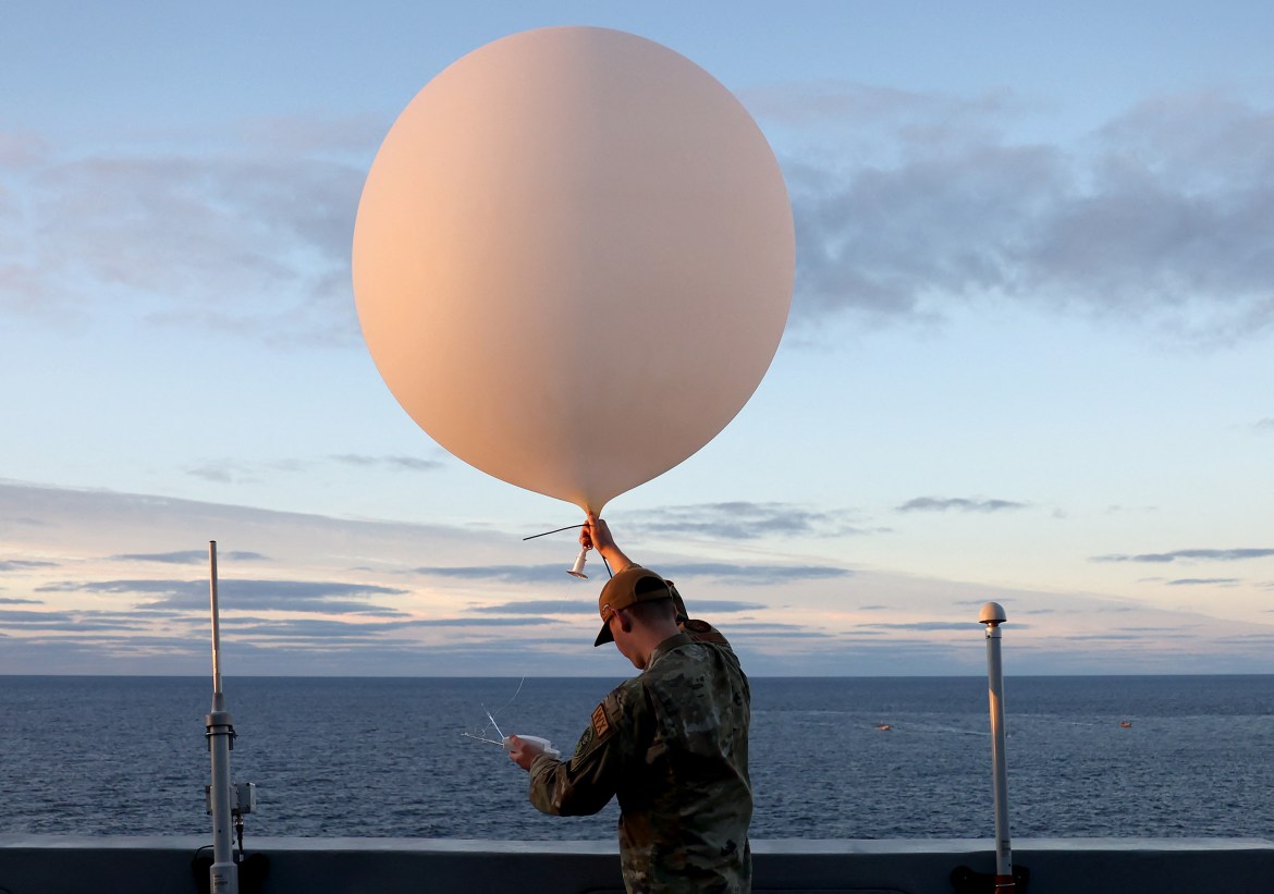 A member of the US Air Force deploys a weather ballon