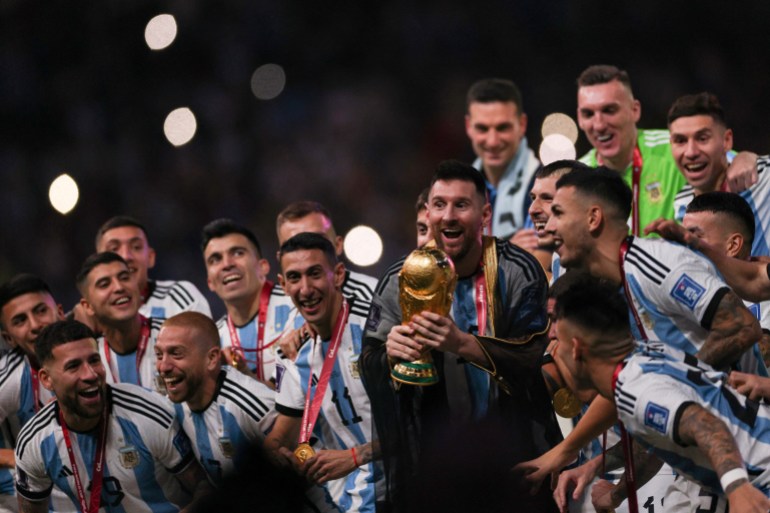 Le capitaine et attaquant argentin # 10 Lionel Messi soulève le trophée de la Coupe du monde de la FIFA lors de la cérémonie de remise des trophées après que l'Argentine a remporté le match de football final de la Coupe du monde Qatar 2022 entre l'Argentine et la France au stade Lusail à Lusail, au nord de Doha, le 18 décembre 2022. (Photo par Adrien DENNIS / AFP)
