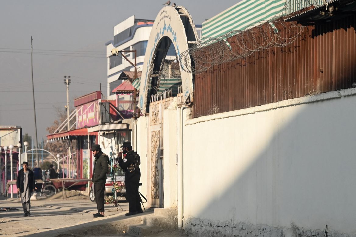 Taliban security personnel stand guard at the entrance