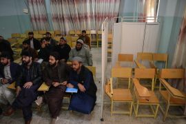 Male university Students attend class bifurcated by a curtain separating males and females at a university in Kandahar Province