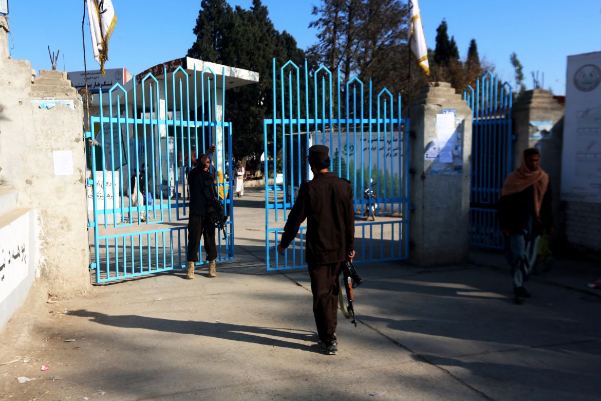 Taliban security personnel stand guard at the entrance
