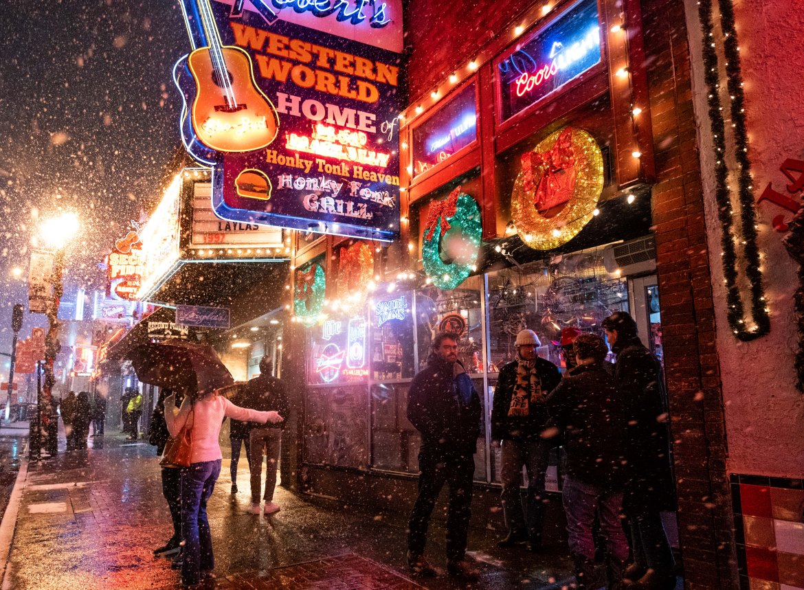 Snow falls on Broadway, a popular tourist street in Nashville,