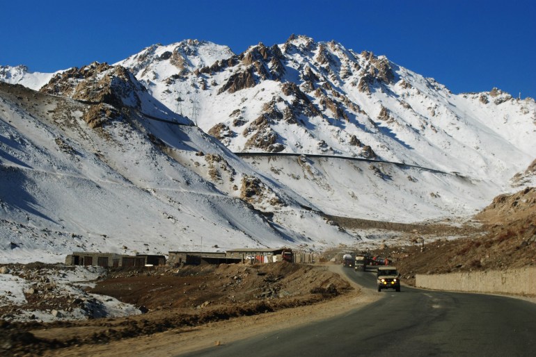 Car drive down a highway on Salang pass in Parwan province on December 13, 2011. Salang pass connects the north of Afghanistan and central Asian countries to Pakistan. AFP PHOTO/ Qais USYAN (Photo by QAIS USYAN / AFP)