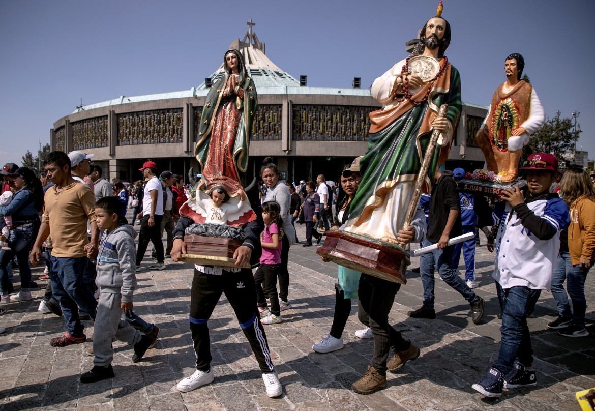Pilgrimage parishioners carry statues