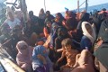 Rohingya refugees many of them women and some with childrem crowded onto a wooden boat stranded off Aceh in Indonesia. They look worried . The women are mostly veiled