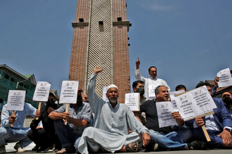 Demonstrators hold placards as they shout slogans during a protest against minorities killings in Kashmir, in Srinagar June 2, 2022. REUTERS/Danish Ismail