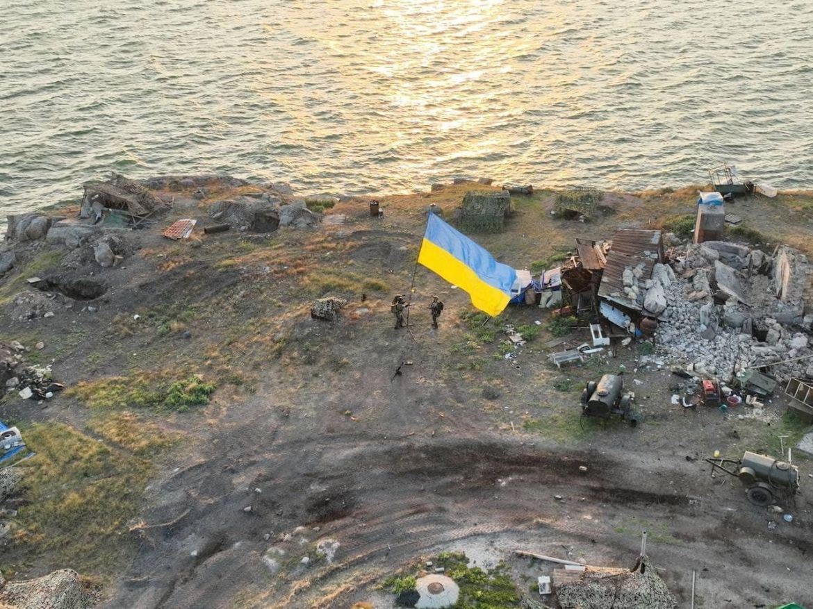 Ukrainian service members install a national flag on Snake (Zmiinyi) Island