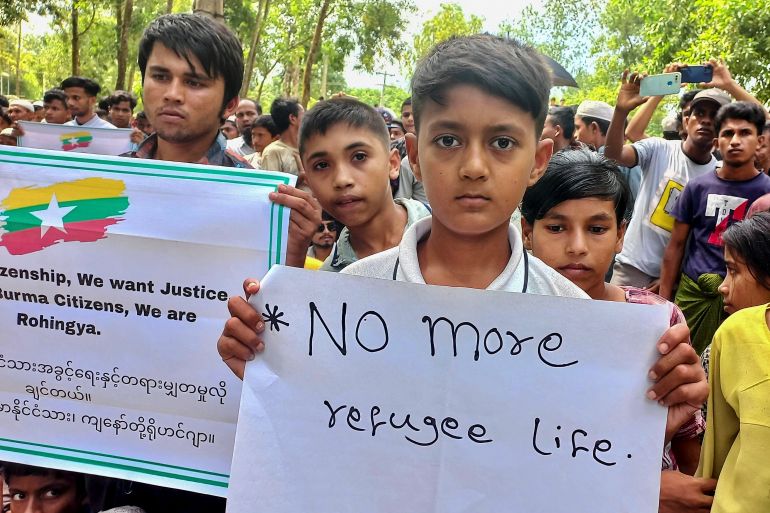 Rohingya refugee children hold placards as they gather at the Kutupalong Refugee Camp to mark the fifth anniversary of their fleeing from neighbouring Myanmar to escape a military crackdown