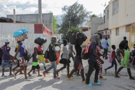 People displaced by gang violence walk on the streets of the Delmas neighbourhood in Port-au-Prince, which has seen surging violence and instability in recent months [File: Ralph Tedy Erol/Reuters]