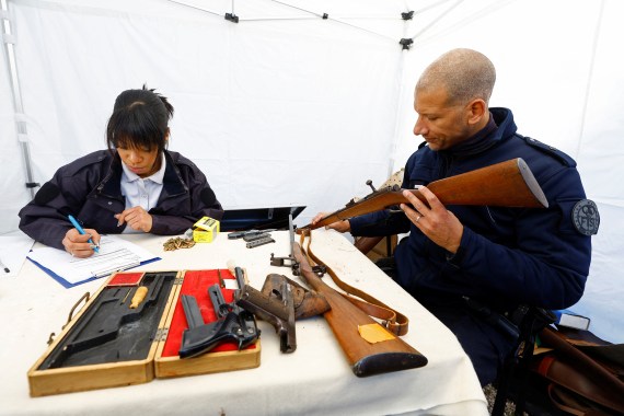 Police officers look at undeclared firearms owned by residents at a police station in Nice as part of an unprecedented collection campaign organised by French authorities to reduce the number of illegally-held weapons in France