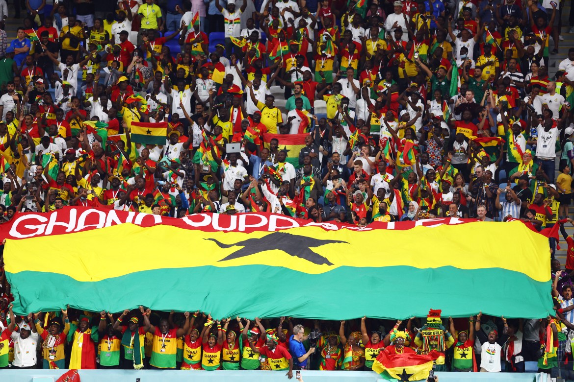 Ghana fans hold a Ghana flag inside the stadium