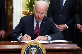 Joe Biden signs a bill averting a railway strike at the White House