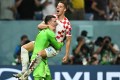 Croatia's Mario Pasalic celebrates with teammate Dominik Livakovic after scoring the winning penalty during the penalty shootout