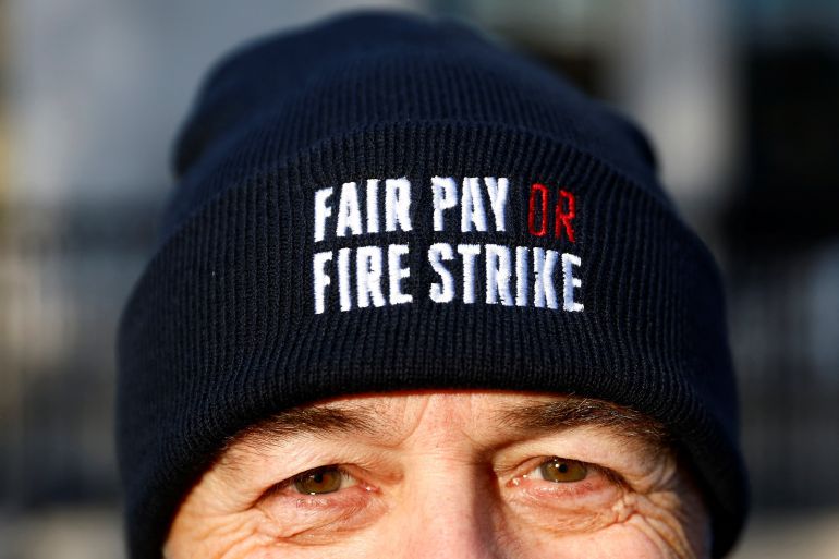 A members of the Fire Brigades Union takes part in a rally regarding possible future strike action linked to a pay dispute, in London, Britain.