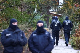 Police secure the area after 25 suspected members and supporters of a far-right group were detained during raids across Germany [Christian Mang/Reuters]