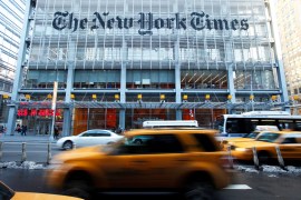Vehicles drive past the New York Times headquarters in New York