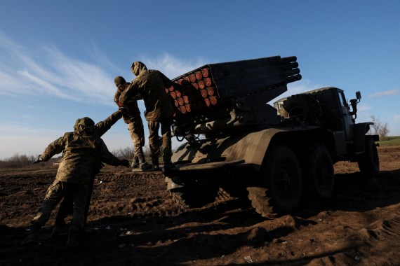 Service members with the Ukrainian Army's 10th Mountain Assault Brigade unit prepare a BM-21 Grad self- propelled multiple rocket launcher