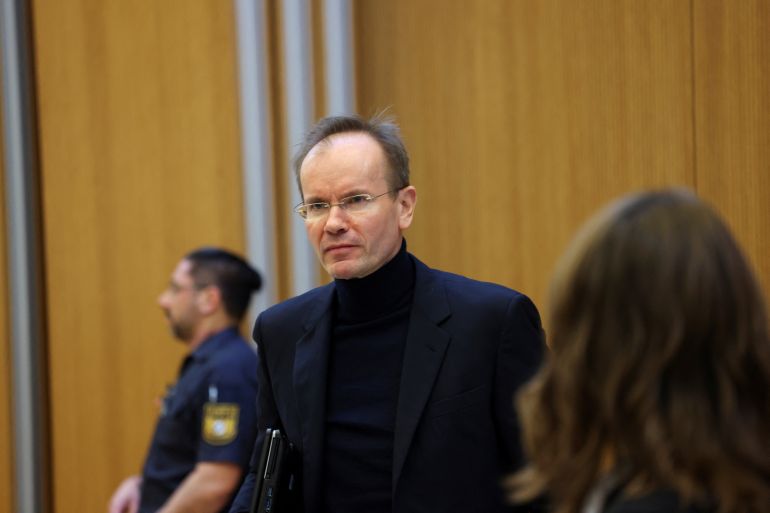 Wirecard's former CEO Markus Braun looks on from inside a courtroom as his trial begins