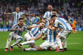Argentina players celebrate after winning the penalty shoot out as Argentina progress to the semi finals [Kai Pfaffenbach/Reuters]