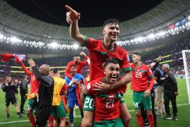 Morocco's Achraf Dari and Walid Cheddira celebrate after beating Portugal on December 10, 2022