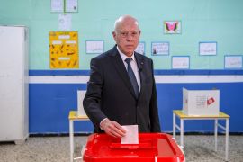 Tunisia's President Kais Saied casts his ballot at a polling station during parliamentary elections in Tunisia.