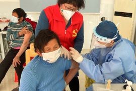 A medical worker administers a dose of a vaccine against coronavirus disease (COVID-19)