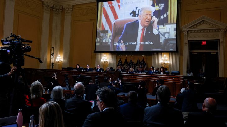 FILE PHOTO: Members of the U.S. House Select Committee investigating the January 6 Attack on the U.S. Capitol sit beneath an image showing former President Donald Trump speaking on the telephone in the Oval Office during the final meeting of the U.S. House Select Committee investigating the January 6 Attack on the U.S. Capitol, on Capitol Hill in Washington, U.S., December 19, 2022. REUTERS/Evelyn Hockstein/File Photo