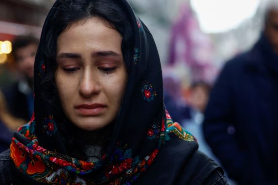 A member of the Kurdish community reacts during a march organised by the Kurdish Democratic Council in France (CDK-F) in tribute to the victims of Friday's deadly attack, in Paris