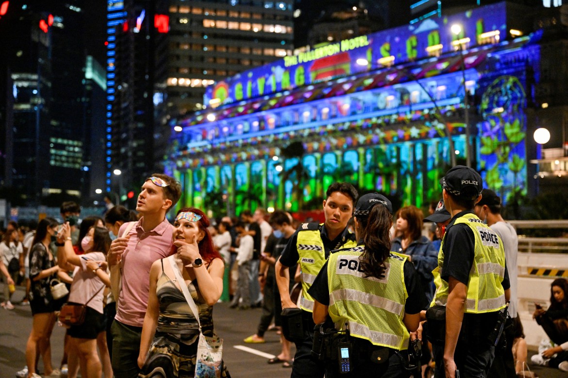 Police patrol the streets for crowd control during the New Year countdown at Marina Bay, in Singapore.