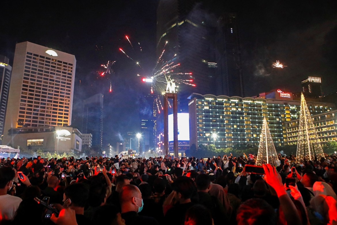 Fireworks explode over the Selamat Datang Monument during New Year's Eve celebrations in Jakarta.