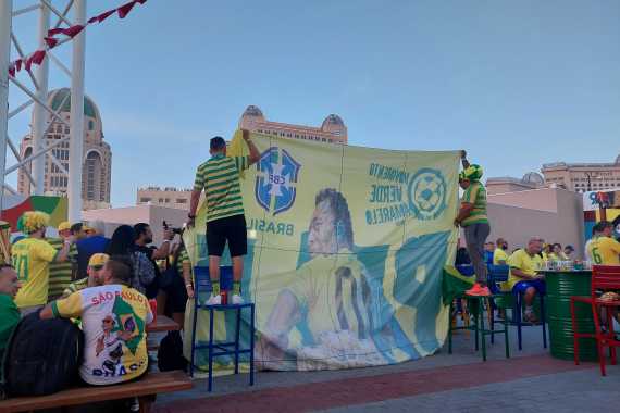 Fans unfurl a giant banner of Pele in Doha, Qatar [Teo Kermeliotis/Al Jazeera]