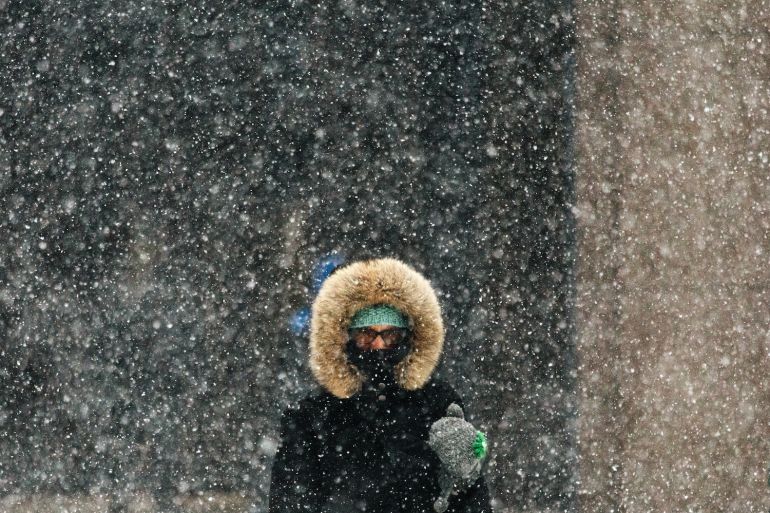 A person walks outside in the snow in New York
